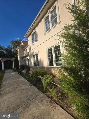 an empty room with windows and ceiling fan