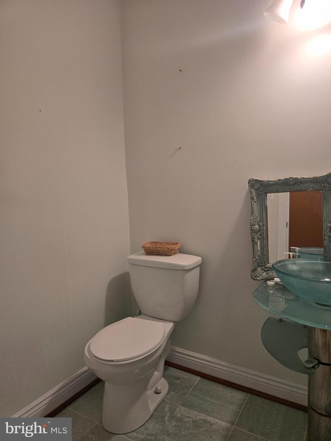 7145 Brooks Road Highland, MD 20777 - Photo 72 of 89 a white toilet sitting next to a bathroom sink