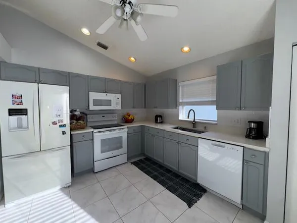 a kitchen with a sink cabinets and stainless steel appliances