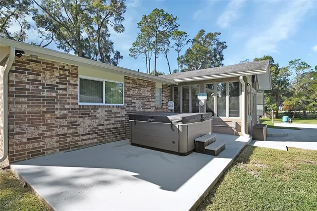 a view of a house with backyard and sitting area