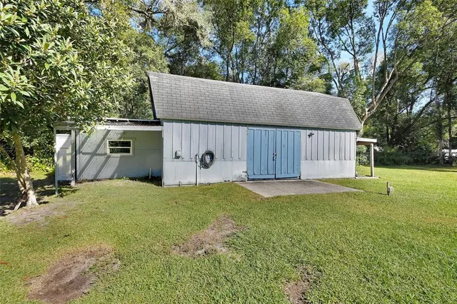 a view of a yard with plants and trees