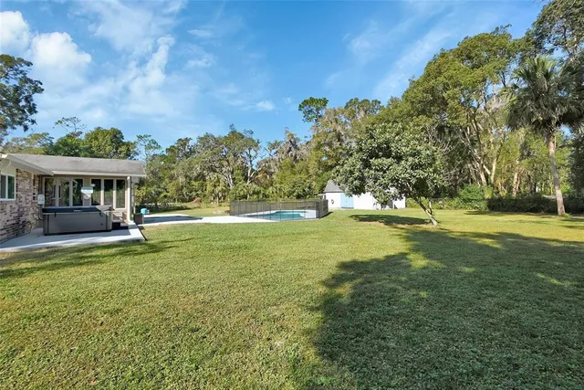 an aerial view of a house with a yard and garden