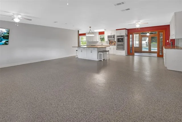 an empty room with a kitchen view and appliances
