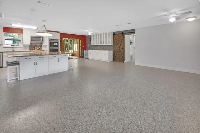 a view of an empty room with a painting on the wall