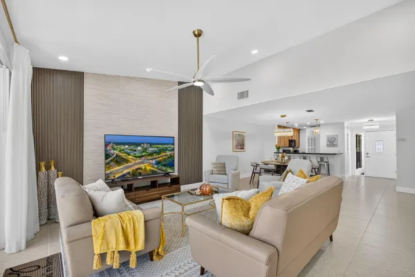 a view of entryway with kitchen and front door