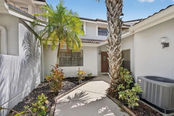 a kitchen with stainless steel appliances a table and chairs in it