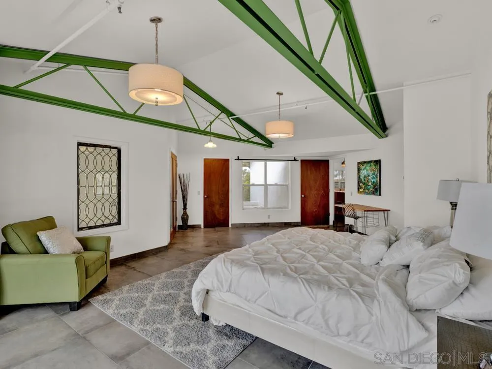 778 Ramona Place Del Mar, CA 92014 - Photo 23 of 72 a bedroom with a bed and a chandelier