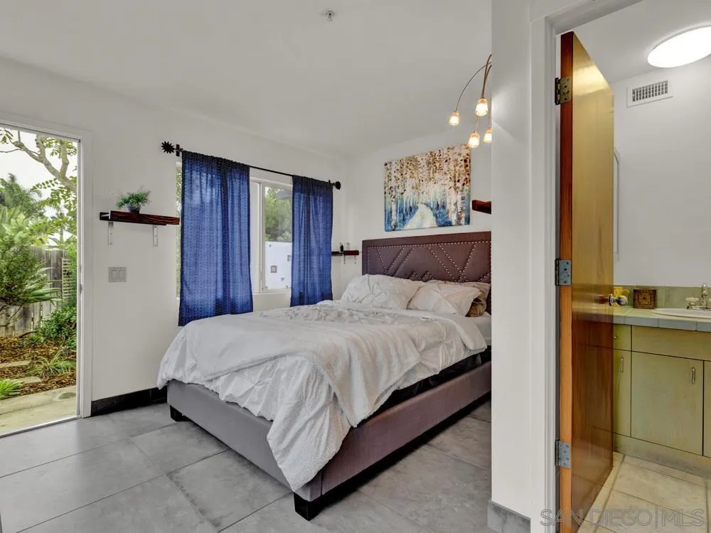 778 Ramona Place Del Mar, CA 92014 - Photo 57 of 72 a bedroom with a large bed and a chandelier