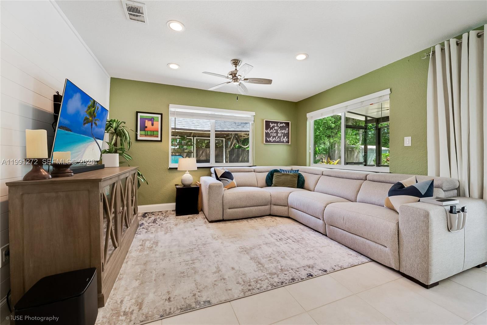 8535 Southwest 97th Road Miami, FL 33173 - Photo 9 of 28 a living room with furniture and a flat screen tv