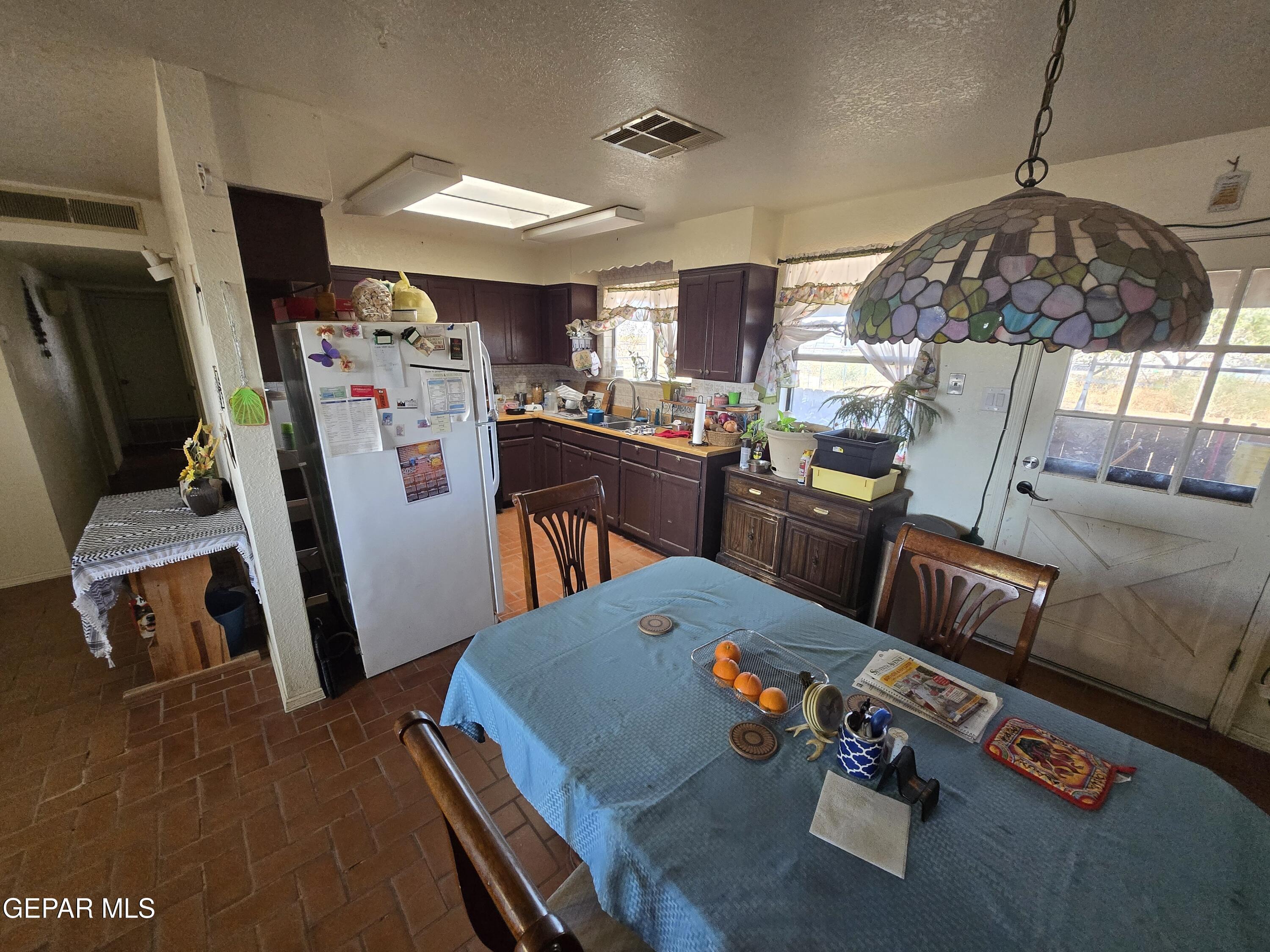 625 Tumbleweed Road Chaparral, NM 88081 - Photo 11 of 17 a living room with furniture and a flat screen tv