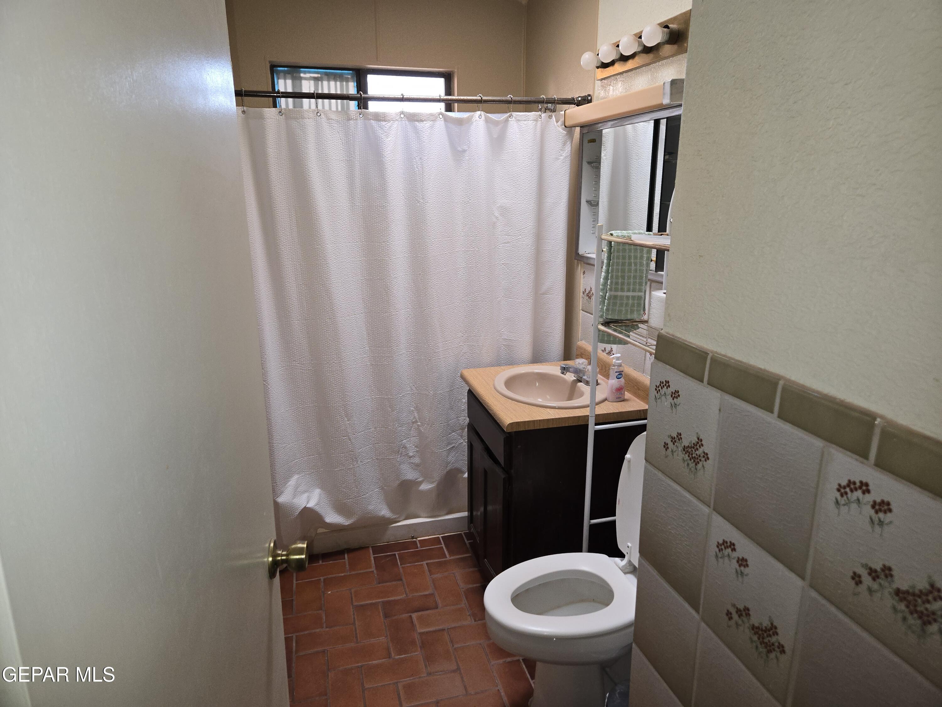 625 Tumbleweed Road Chaparral, NM 88081 - Photo 16 of 17 a bathroom with a sink toilet and shower