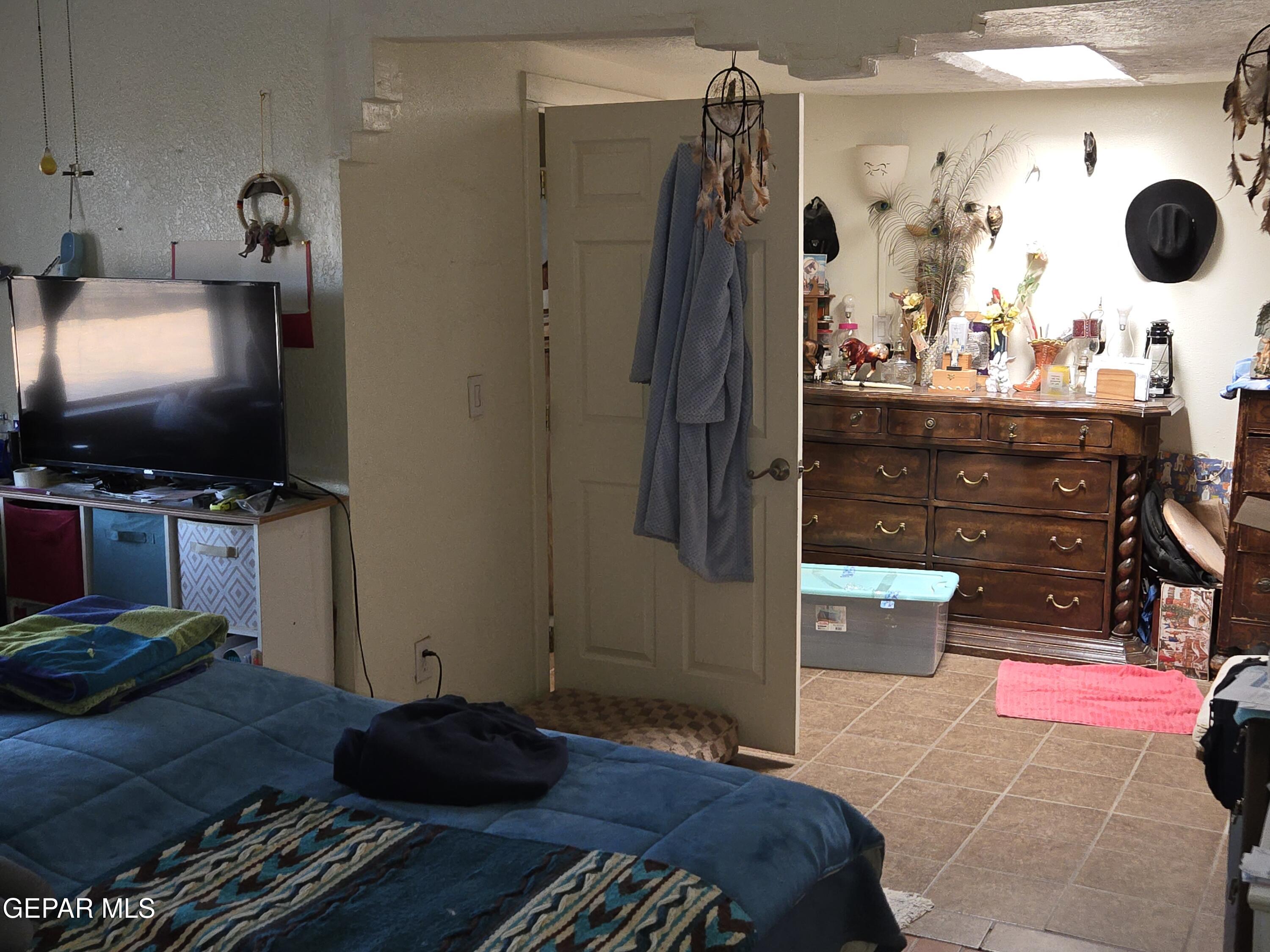 625 Tumbleweed Road Chaparral, NM 88081 - Photo 17 of 17 a bedroom with a bed and a flat screen tv