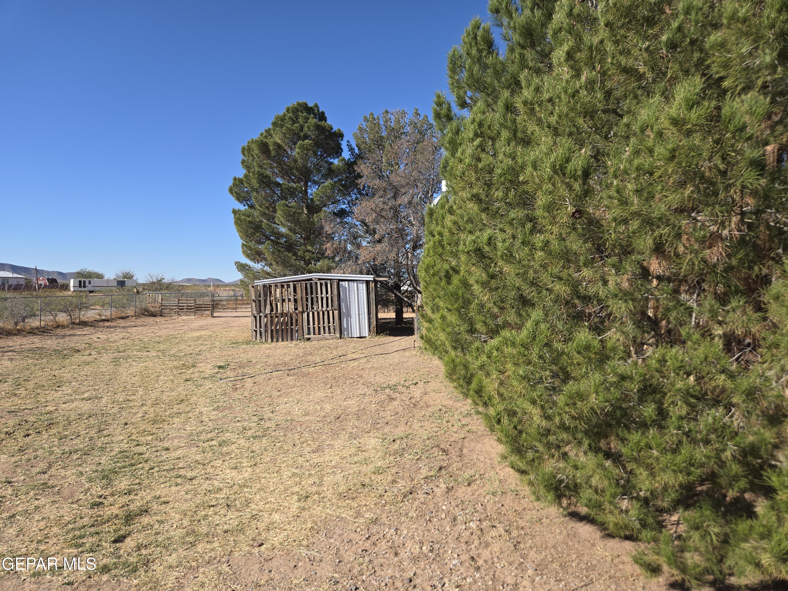 625 Tumbleweed Road Chaparral, NM 88081 - Photo 5 of 17 a view of a dry yard with wooden fence