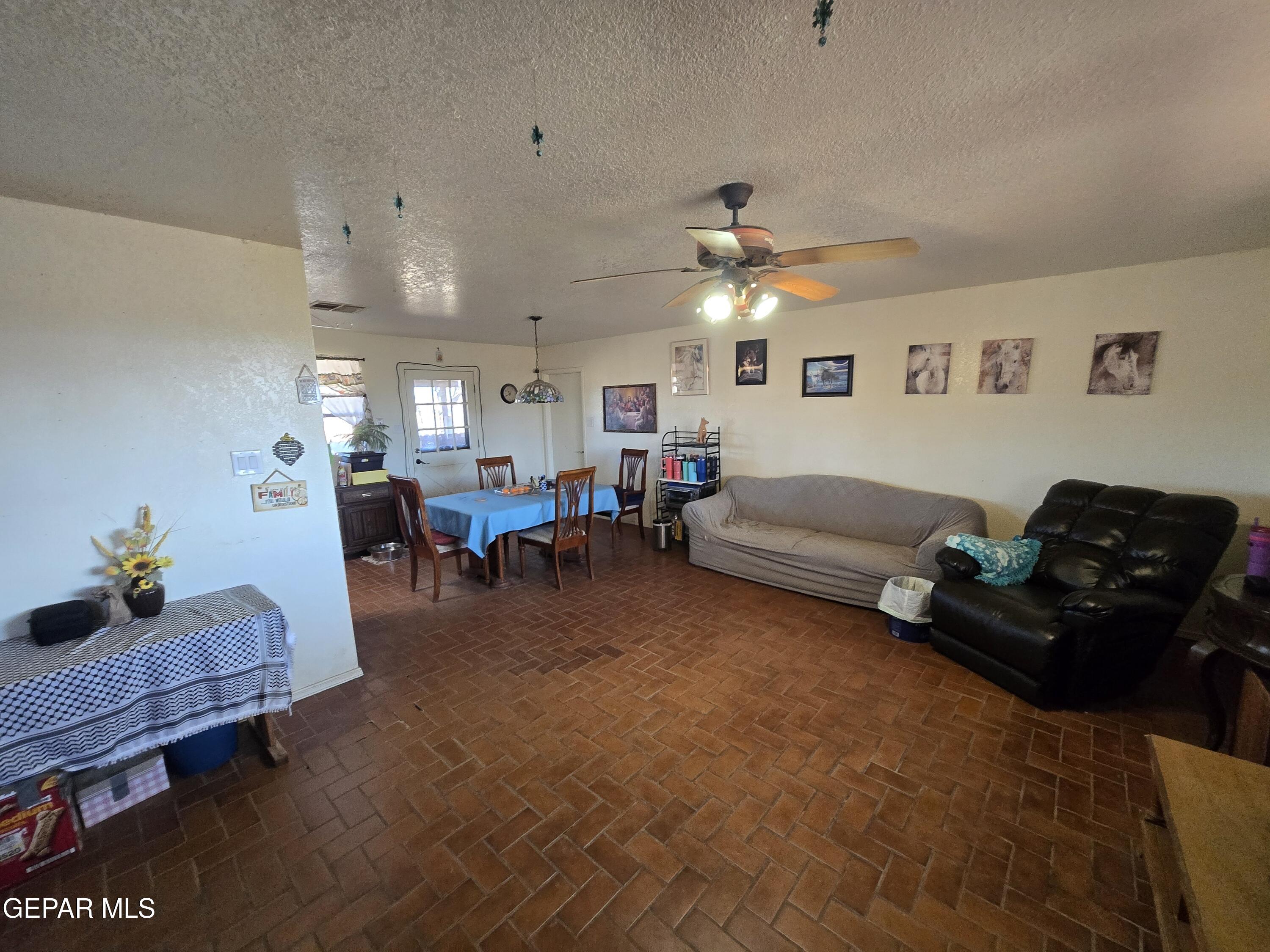 625 Tumbleweed Road Chaparral, NM 88081 - Photo 10 of 17 a living room with furniture and a chandelier