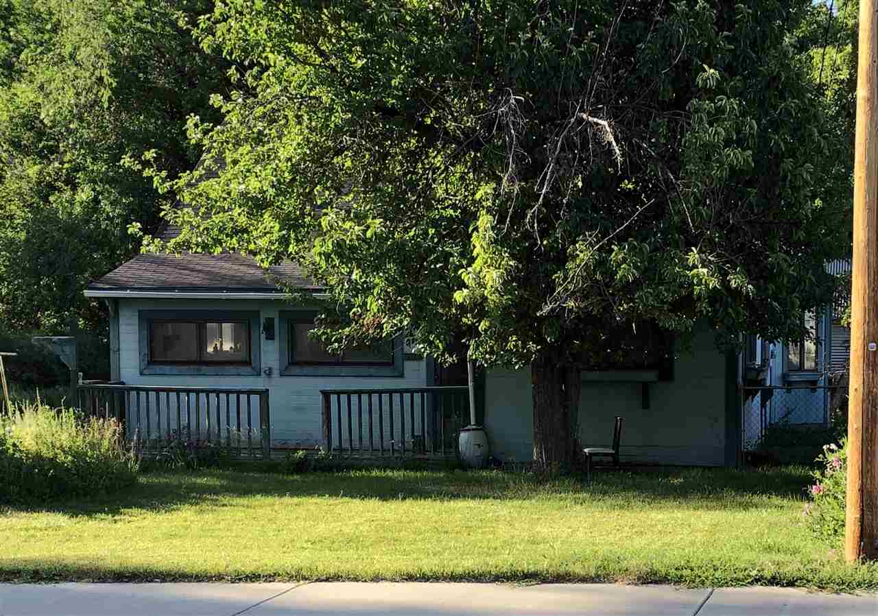a view of a house with a yard and fence