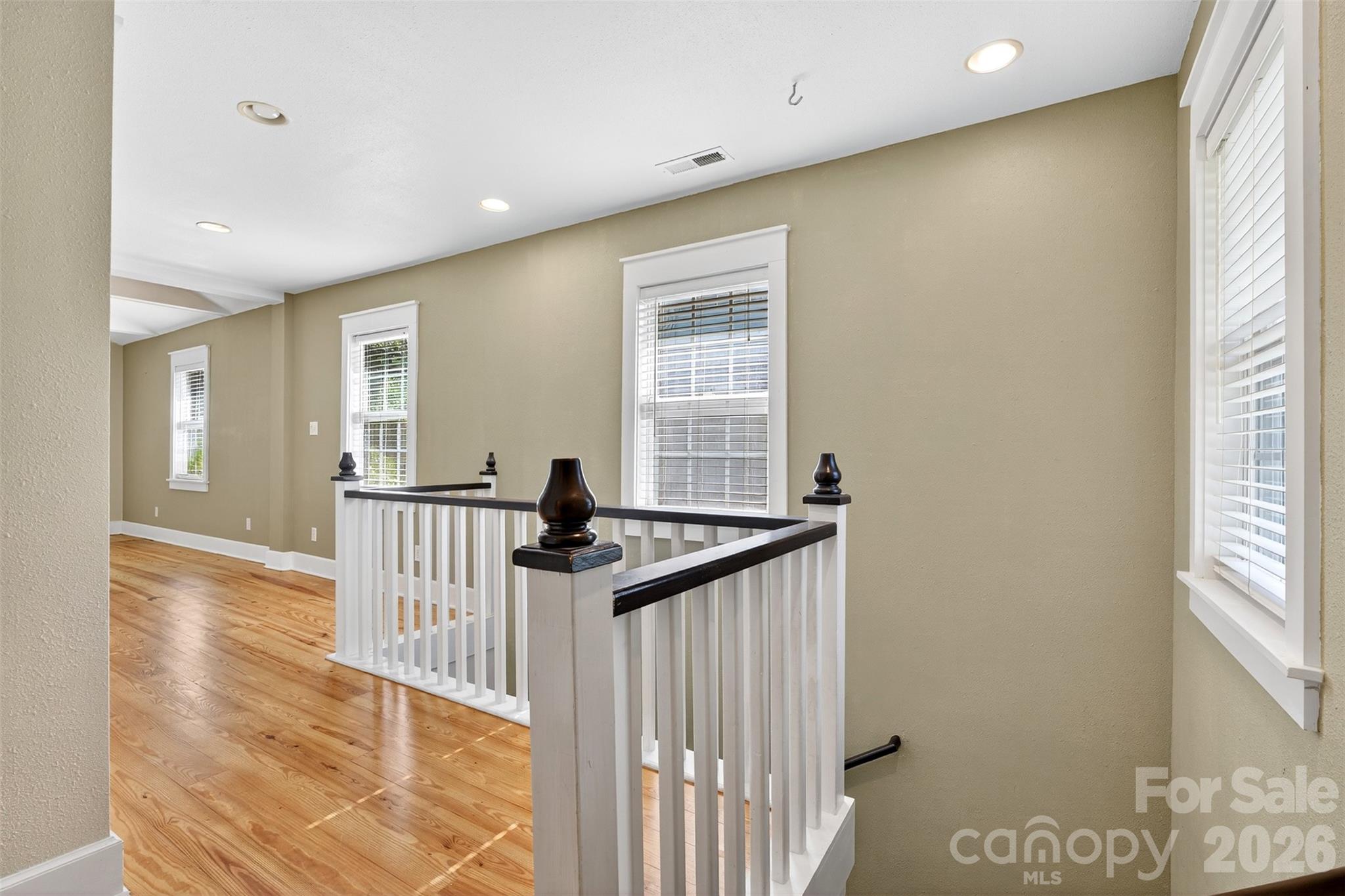 160 East Howard Street Tryon, NC 28782 - Photo 19 of 48 a view of a hallway with a window and wooden floor