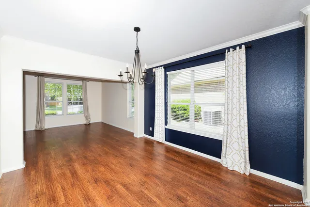 a large kitchen with stainless steel appliances granite countertop a sink and cabinets