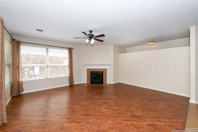 wooden floor in an empty room with a fireplace