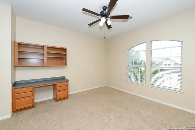 a view of a kitchen with furniture and a ceiling fan