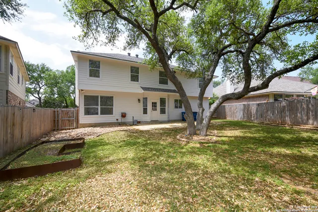 a backyard of a house with large trees
