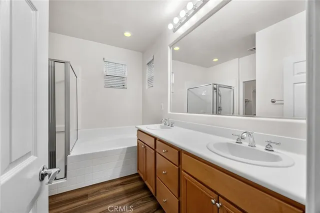 a bathroom with a sink double vanity granite tub and shower