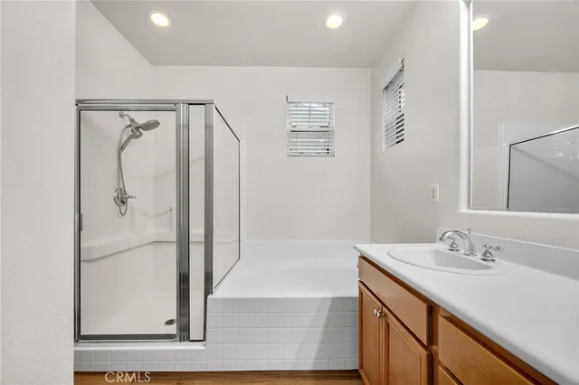 a bathroom with a shower sink and mirror