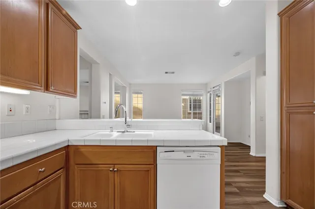 a kitchen with granite countertop cabinets sink and window