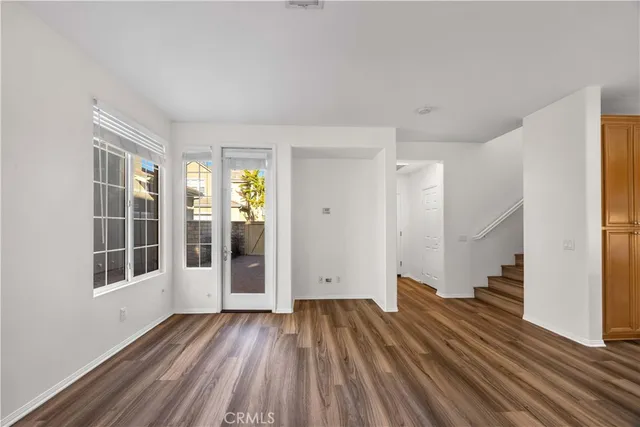 a view of a room with wooden floor and a window