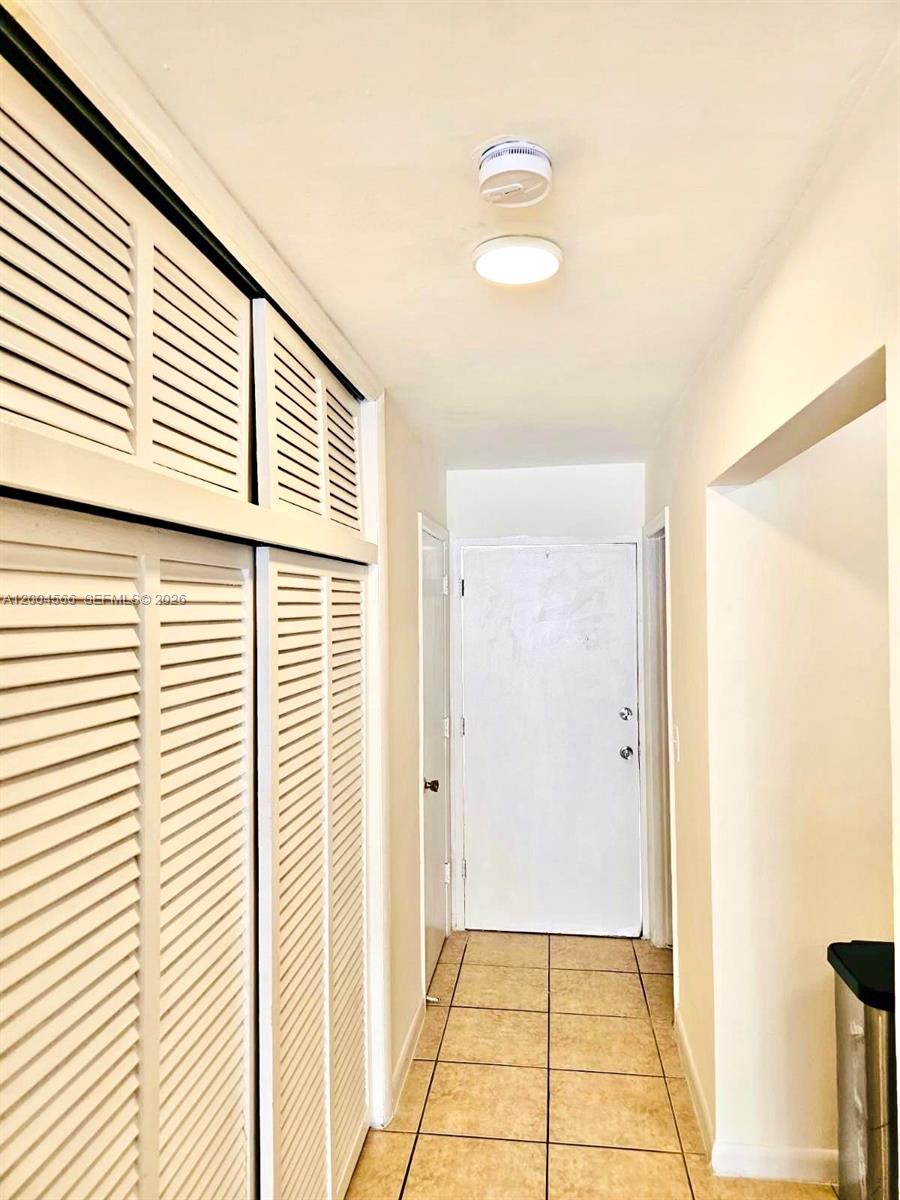1441 Lincoln Road, Unit 212 Miami Beach, FL 33139 - Photo 4 of 9 a view of a hallway with windows