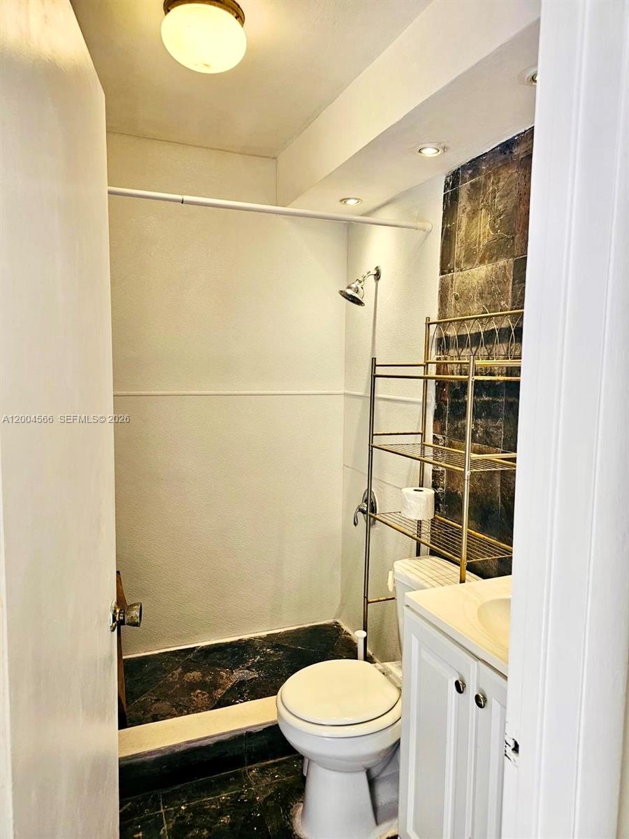 1441 Lincoln Road, Unit 212 Miami Beach, FL 33139 - Photo 7 of 9 a bathroom with a sink and a toilet