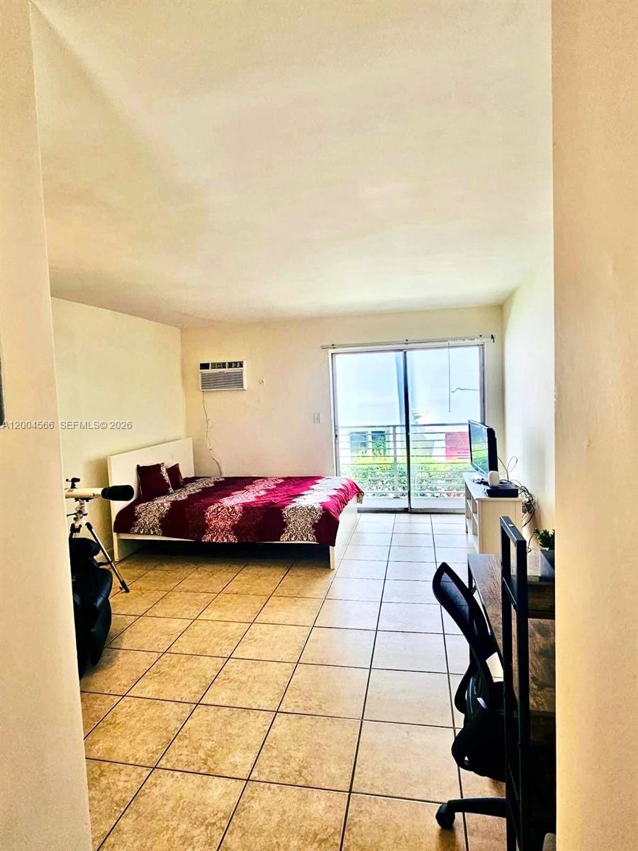 1441 Lincoln Road, Unit 212 Miami Beach, FL 33139 - Photo 8 of 9 a view of a bedroom with furniture and a window