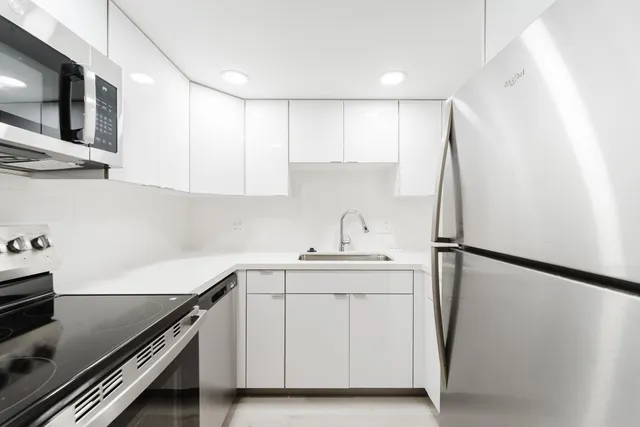 a kitchen with a sink appliances and cabinets