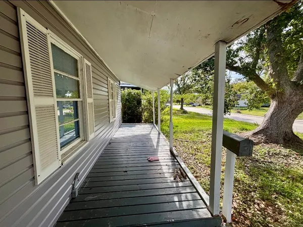 a view of balcony with floor to ceiling windows with wooden floor