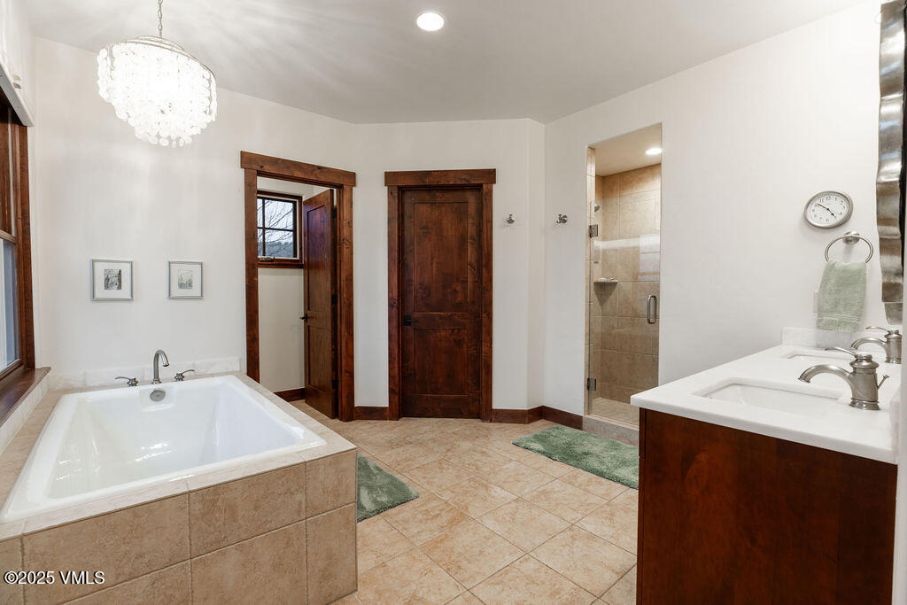 170 Palmer Loop Eagle, CO 81631 - Photo 13 of 37 a bathroom with a sink a mirror and a shower