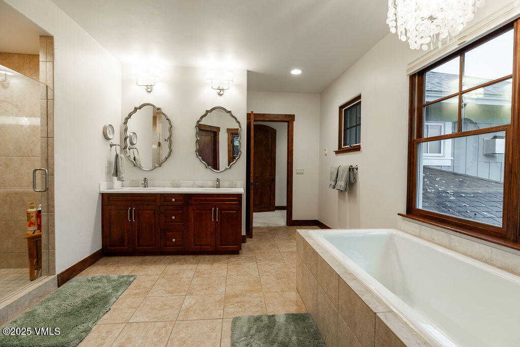170 Palmer Loop Eagle, CO 81631 - Photo 14 of 37 a spacious bathroom with a tub sink and mirror