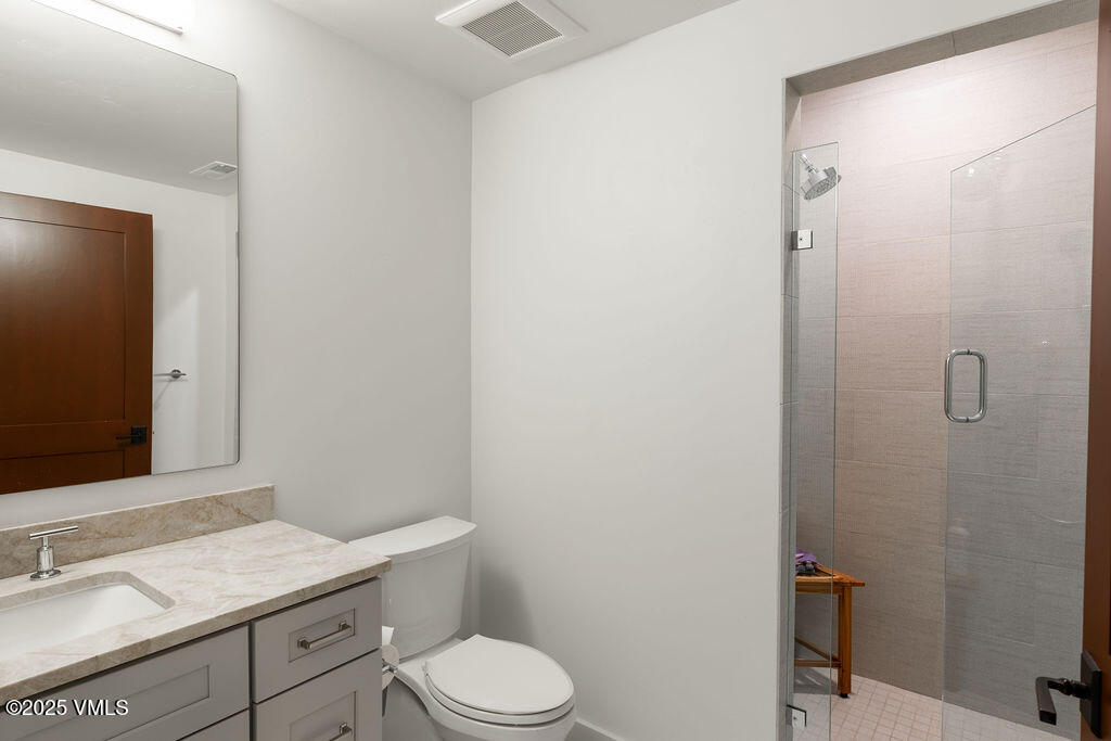 170 Palmer Loop Eagle, CO 81631 - Photo 26 of 37 a bathroom with a granite countertop sink toilet a mirror and shower