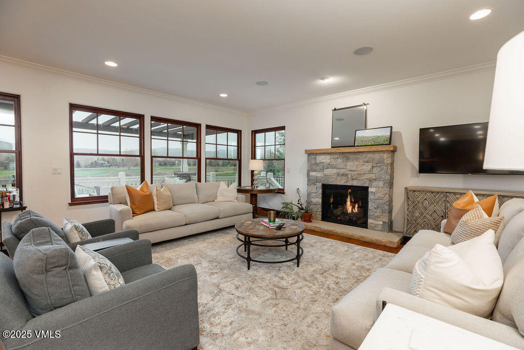 170 Palmer Loop Eagle, CO 81631 - Photo 4 of 37 a living room with furniture a flat screen tv and a fireplace