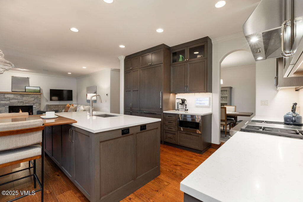 170 Palmer Loop Eagle, CO 81631 - Photo 8 of 37 a large kitchen with stainless steel appliances a stove a sink dishwasher and a refrigerator with wooden floor