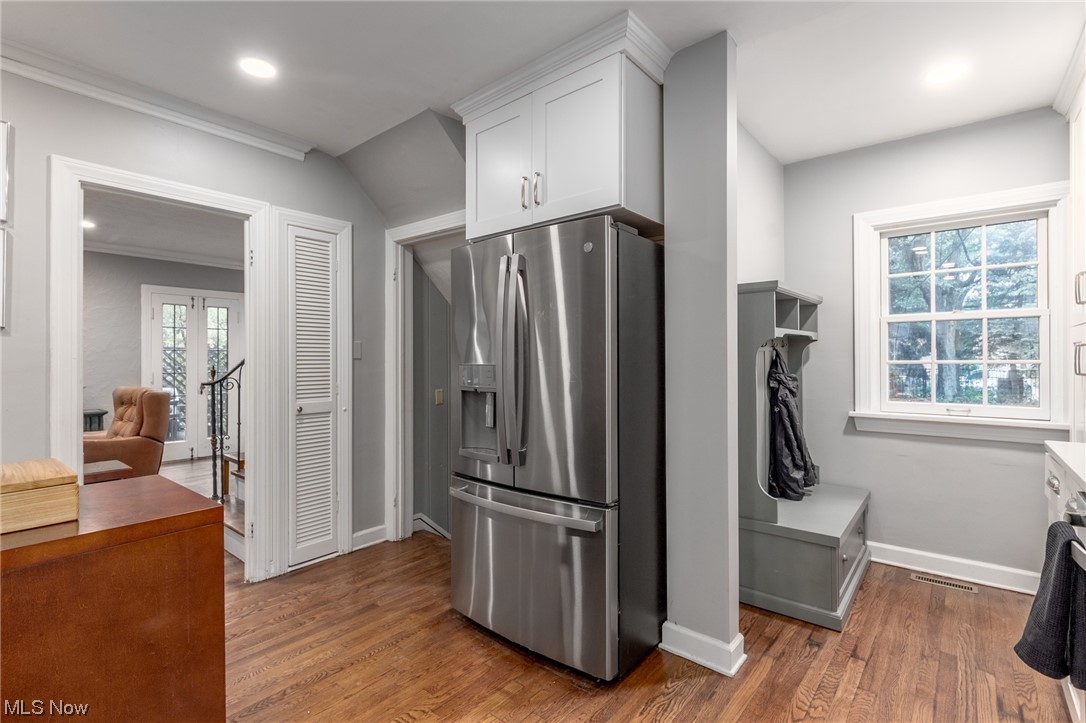 2482 Charney Road Cleveland, OH 44118 - Photo 12 of 34 Kitchen with white cabinets, ornamental molding, french doors, stainless steel refrigerator with ice dispenser, and dark hardwood floors