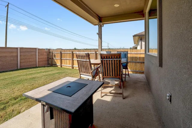 a view of a balcony with a table and chairs