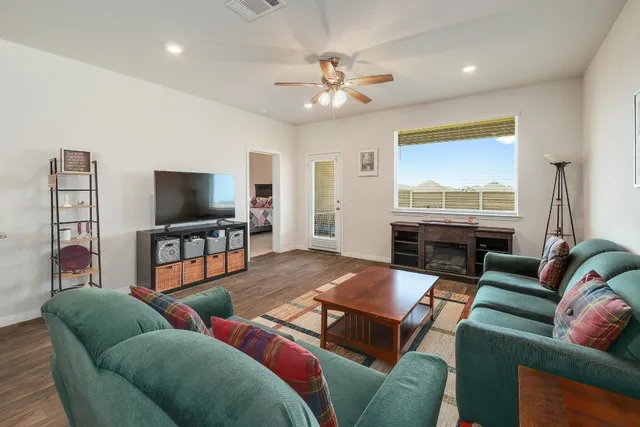 a living room with furniture and a flat screen tv