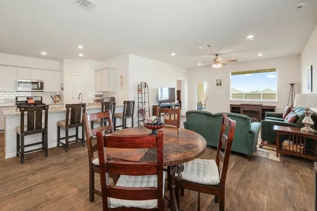 a view of a dining room with furniture and wooden floor