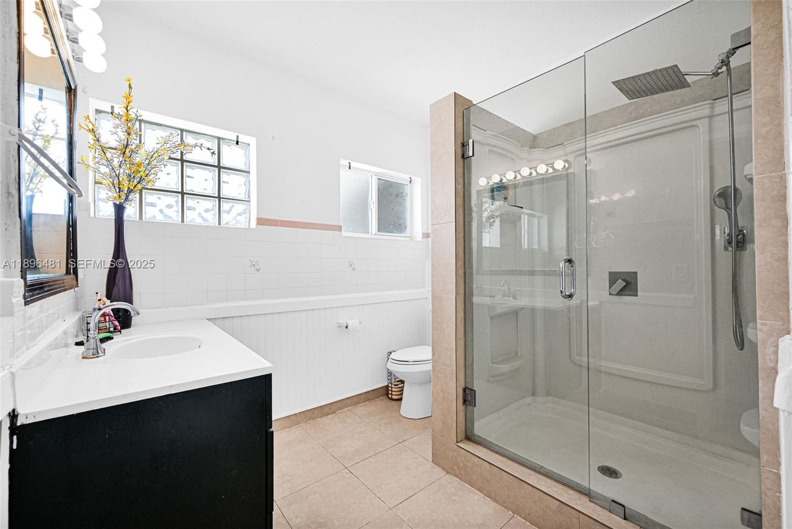 9740 Cutler Ridge Drive Cutler Bay, FL 33157 - Photo 13 of 21 a bathroom with a shower sink vanity and toilet