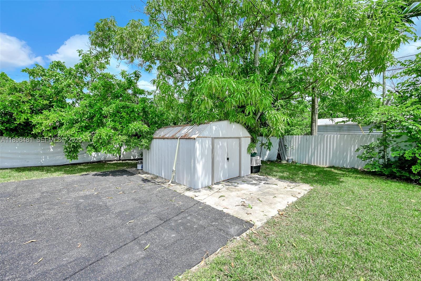 9740 Cutler Ridge Drive Cutler Bay, FL 33157 - Photo 17 of 21 a backyard of a house with large trees and plants