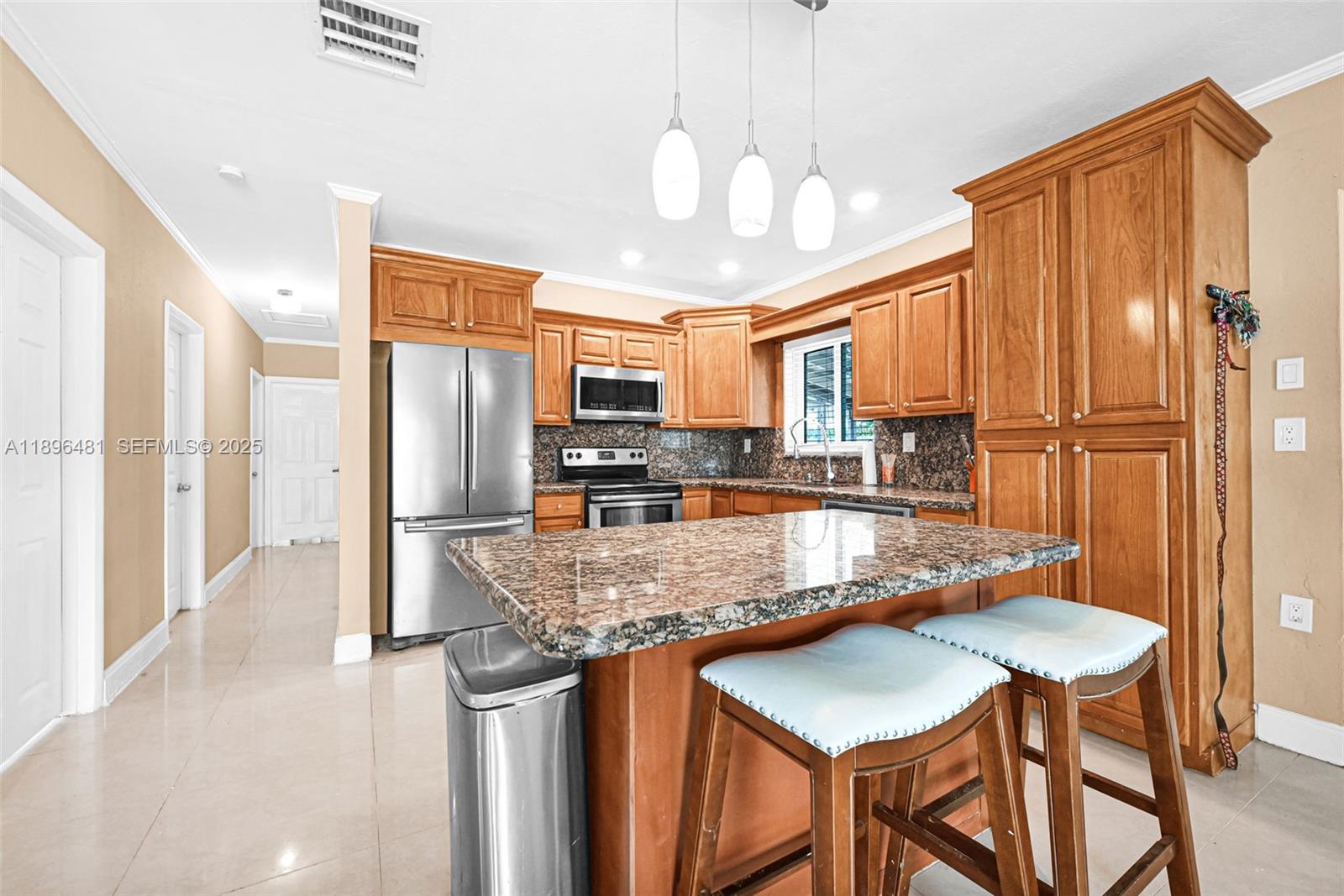 9740 Cutler Ridge Drive Cutler Bay, FL 33157 - Photo 7 of 21 a kitchen with stainless steel appliances granite countertop a stove refrigerator sink and cabinets