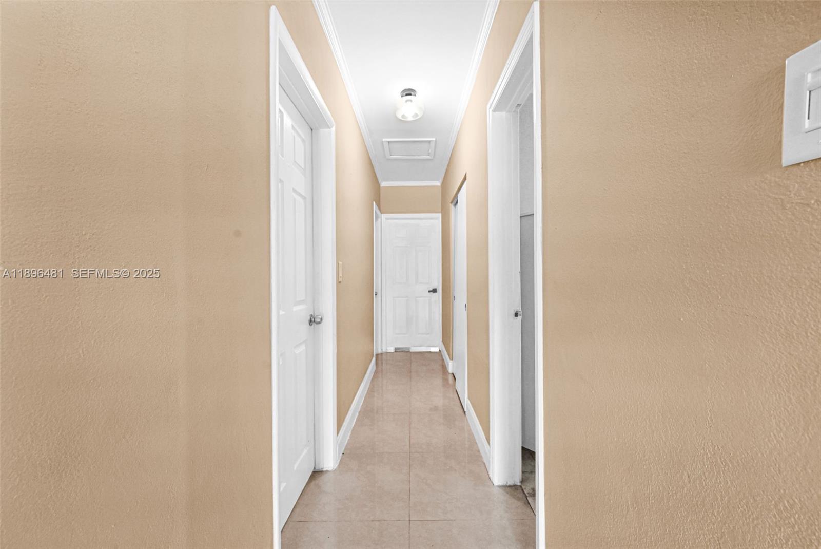 9740 Cutler Ridge Drive Cutler Bay, FL 33157 - Photo 10 of 21 a view of a hallway with wooden floor and a bathroom