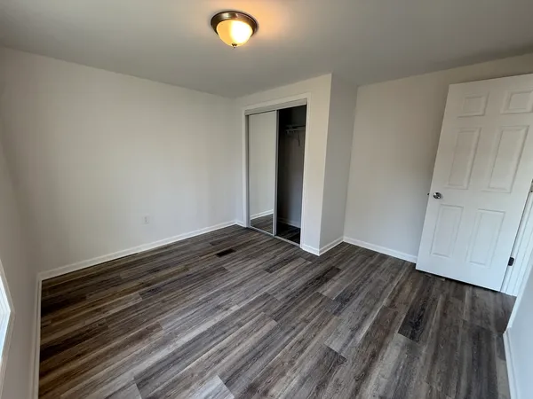 a view of room with wooden floor