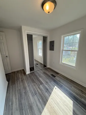 a view of a room with wooden floor and window