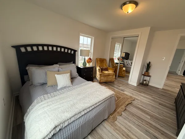 a bed sitting in a bedroom and next to a window