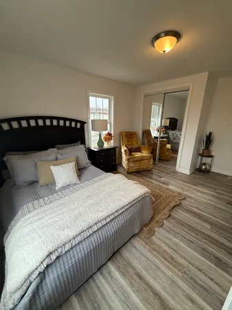a bedroom with bed and window
